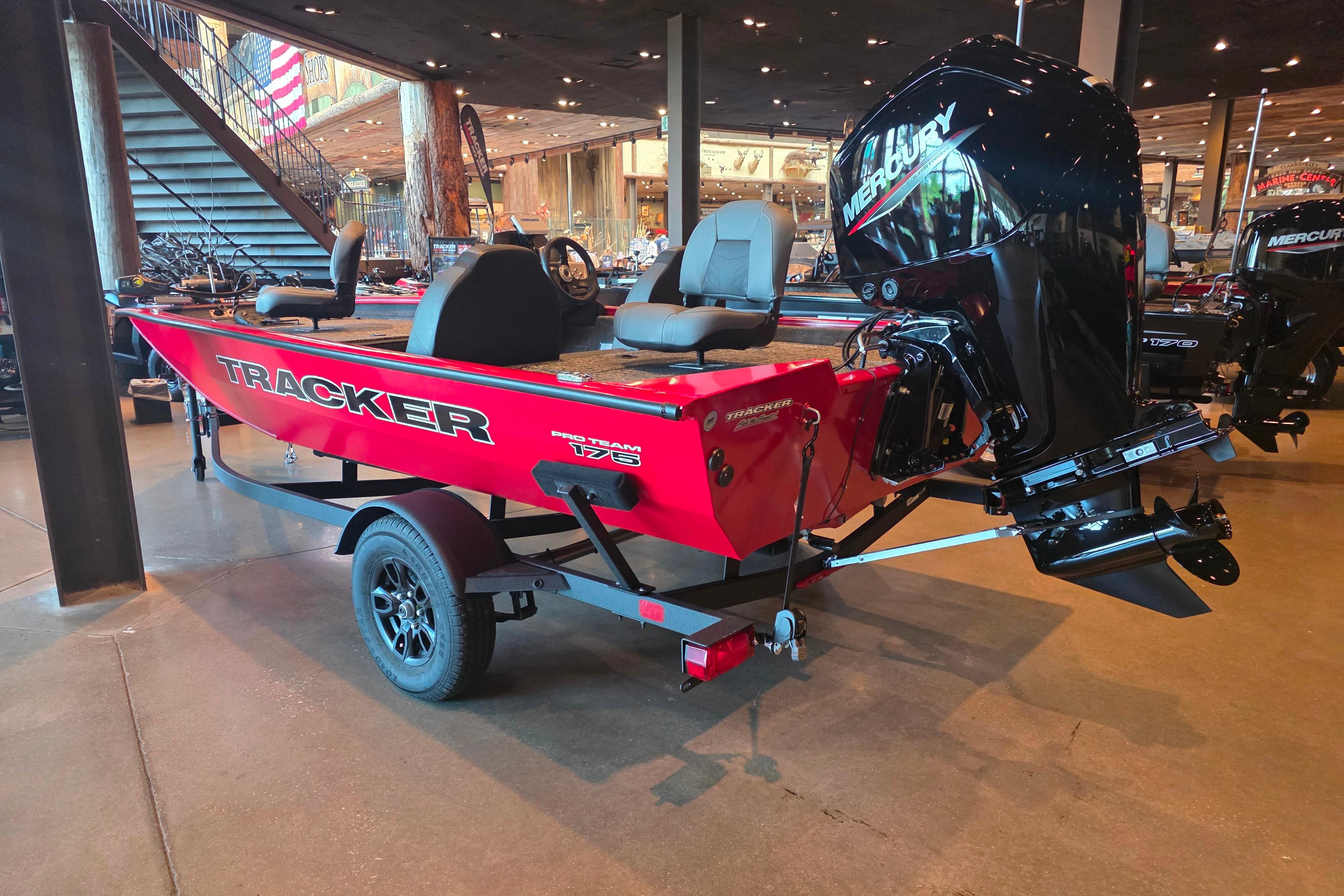2026 Tracker Pro Team 175 boat with Mercury engine, displayed indoors.