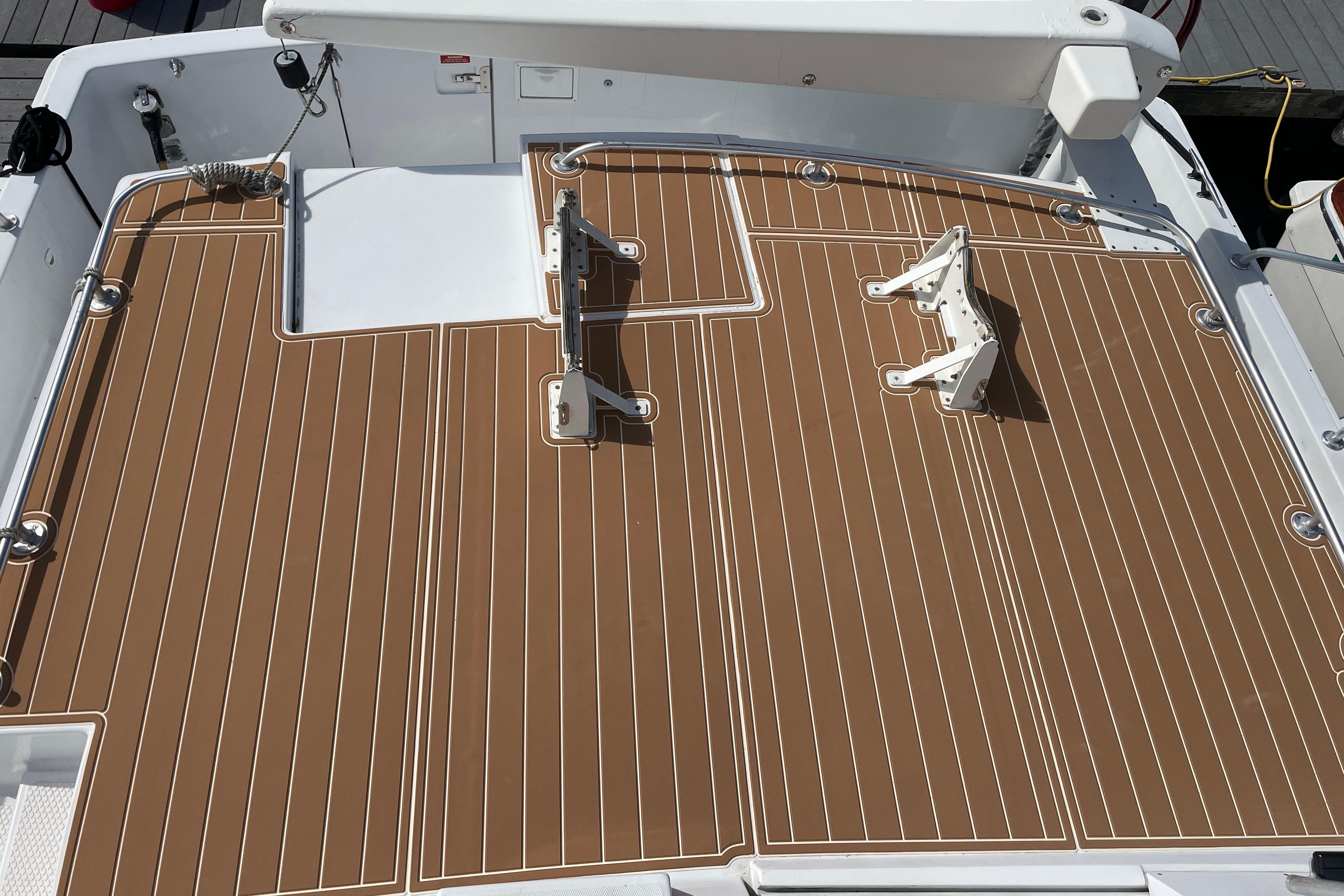 1999 Mainship 430 Trawler deck with brown and white striped flooring.