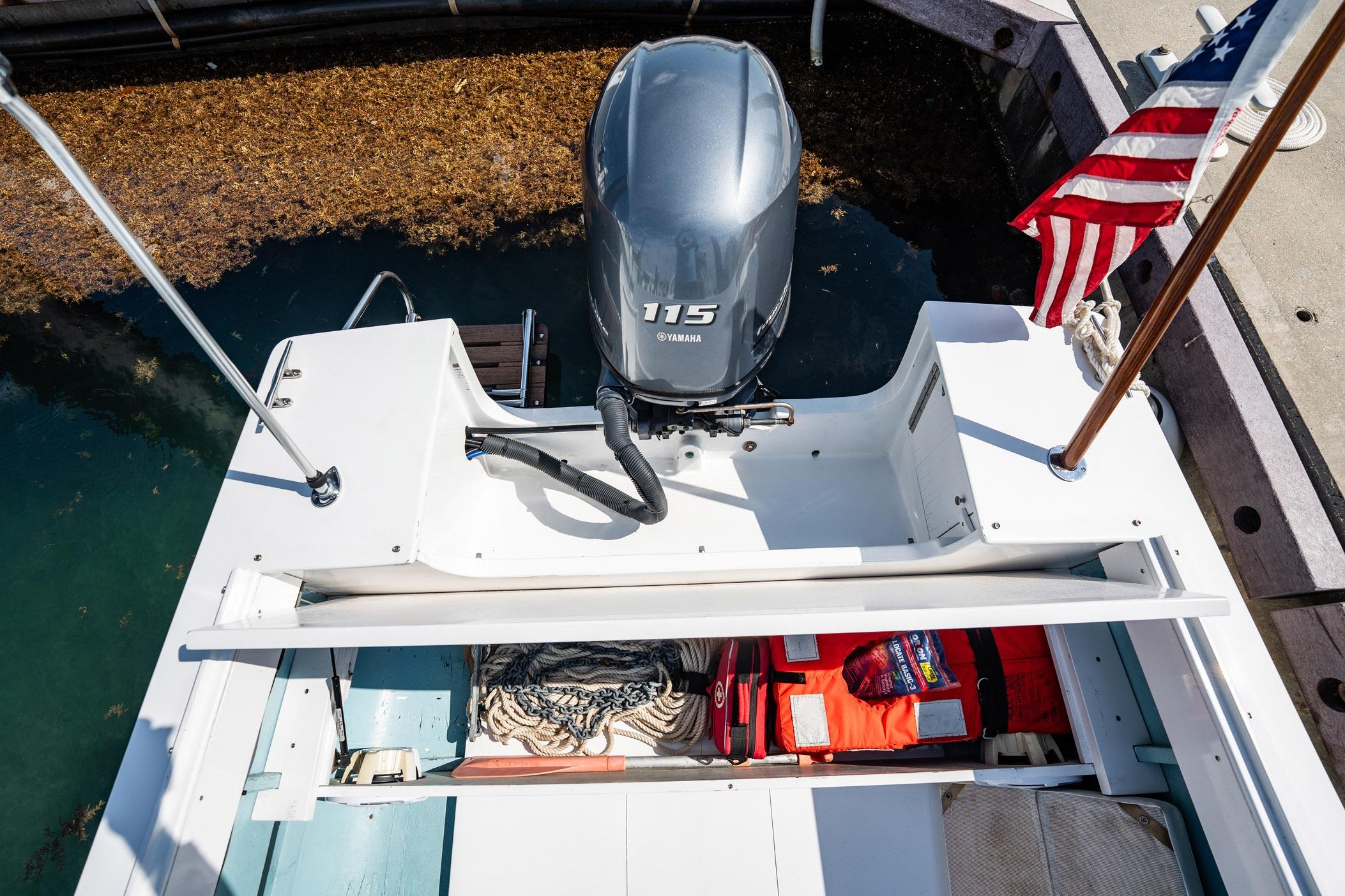 1982 Albury Brothers Runabout with Yamaha 115 engine, docked with American flag.