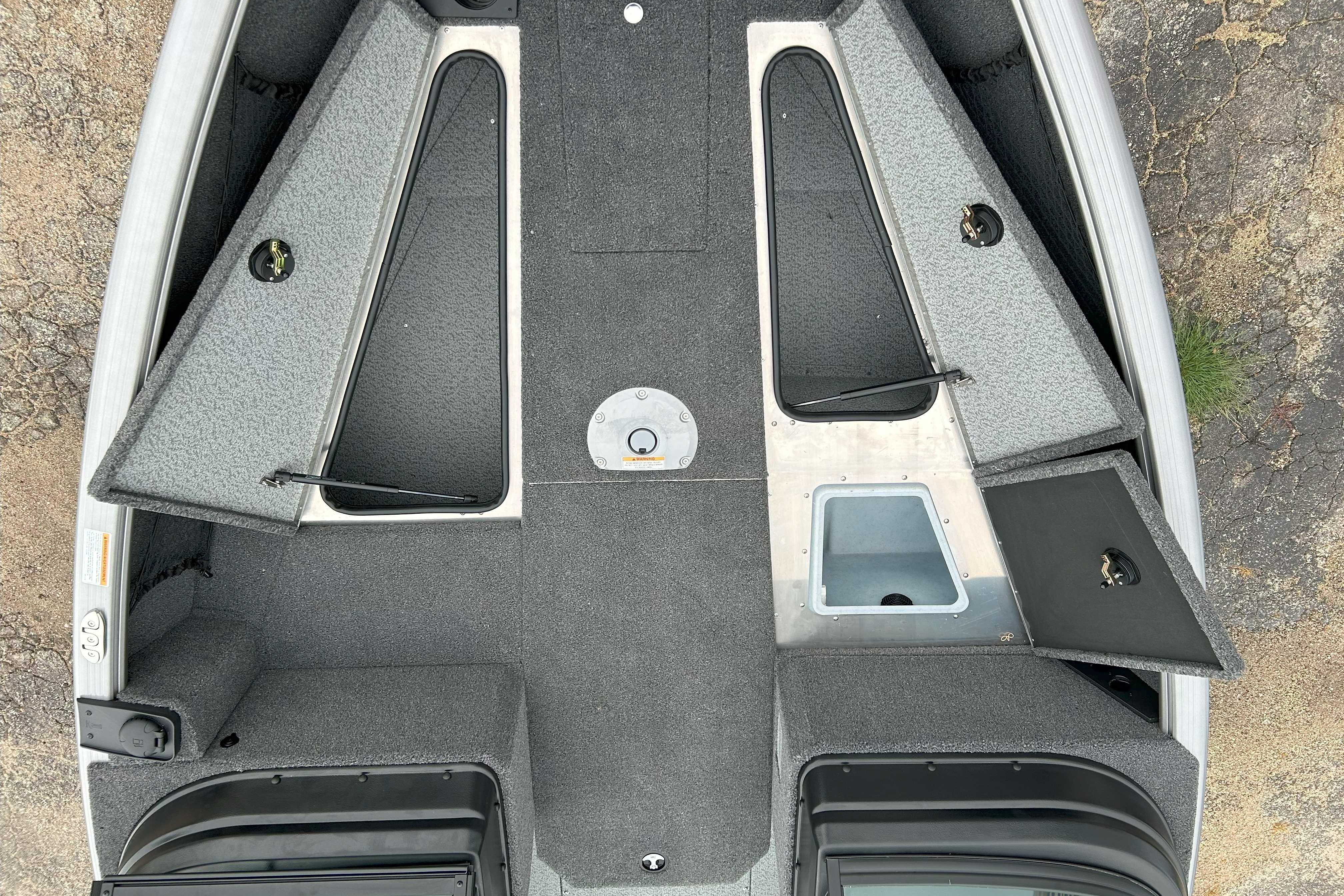 2026 Lund 1875 Impact XS Sport boat interior with open storage compartments.