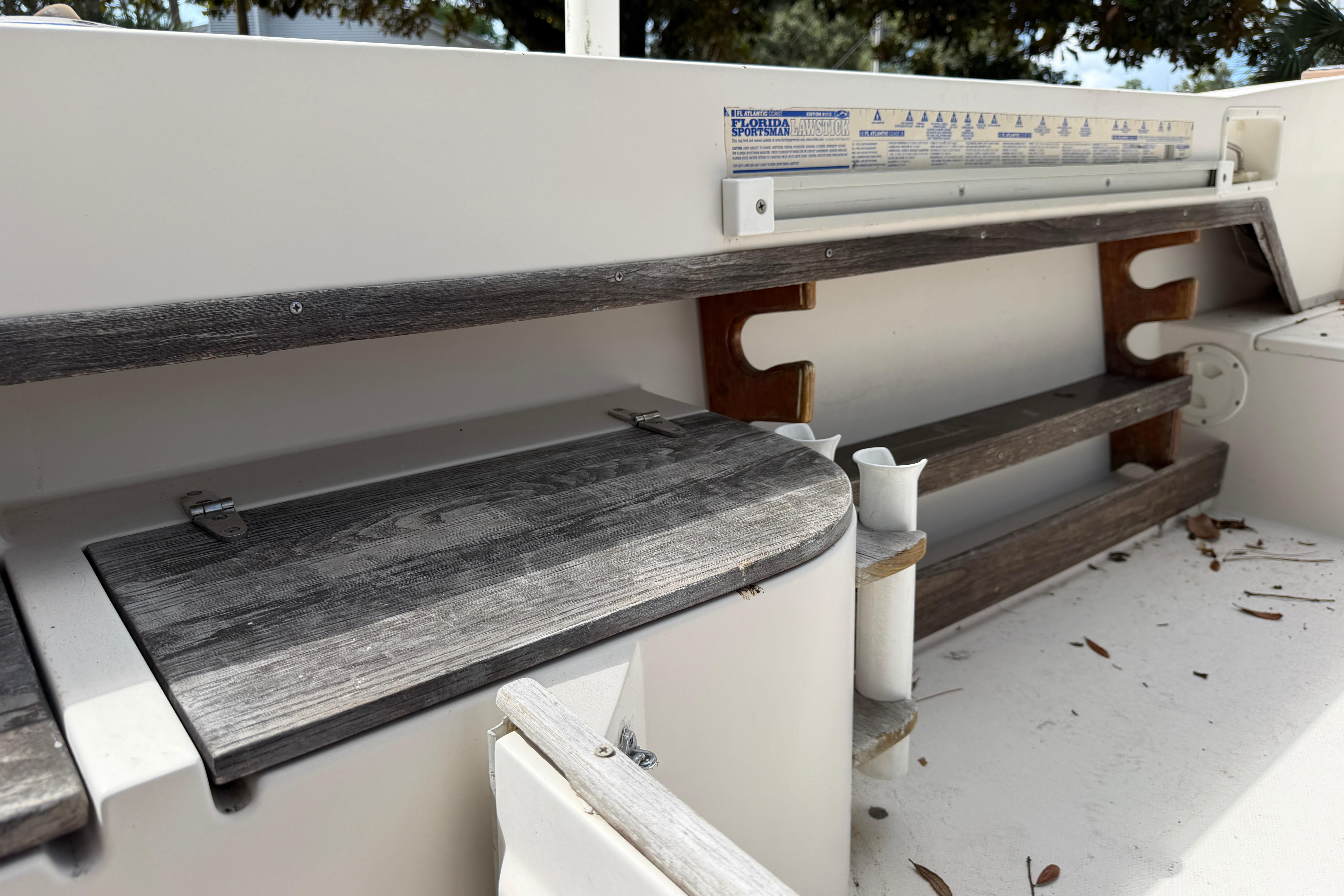 1987 Grady-White Seafarer 226 boat interior with wooden seating and storage compartments.