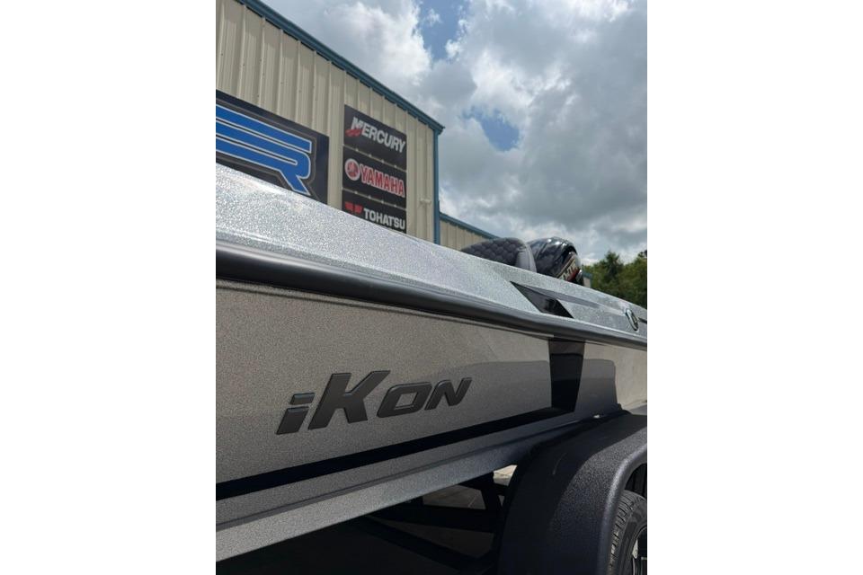 2026 iKon IKON boat parked outside dealership under cloudy sky.