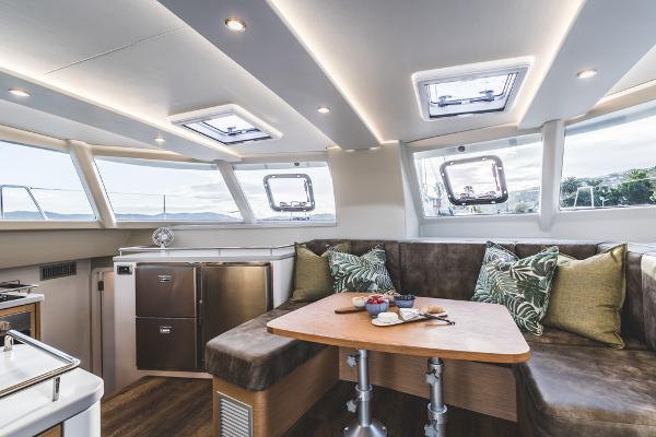 Luxurious Vision 444 yacht interior with modern seating and dining area, 2025 model.