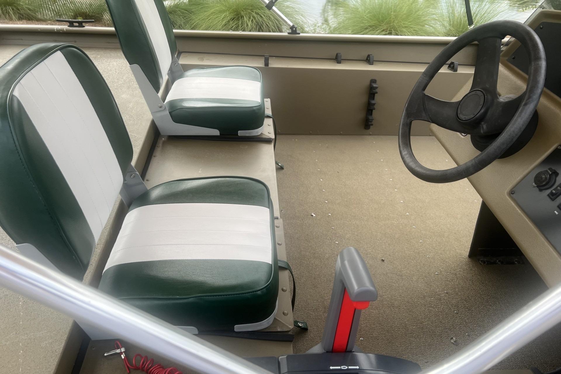 Interior of a 2016 G3 1756 SC boat with dual seats and steering wheel.