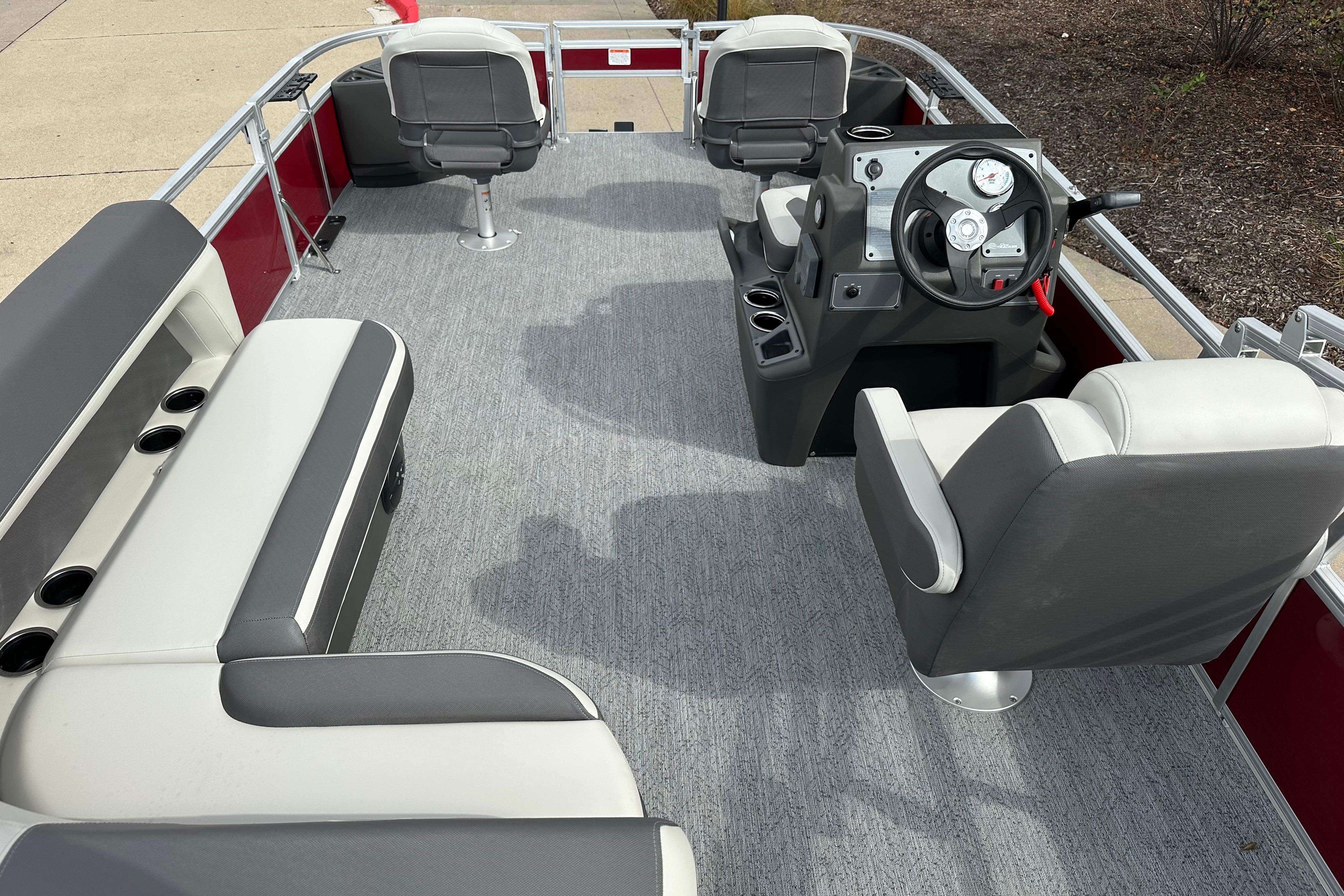 2026 Sun Tracker Bass Buggy 18 DLX pontoon boat interior with seating and steering console.