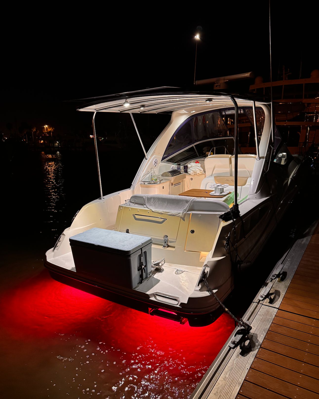 2008 Sea Ray Sundancer 310 with red underwater lights at dock.