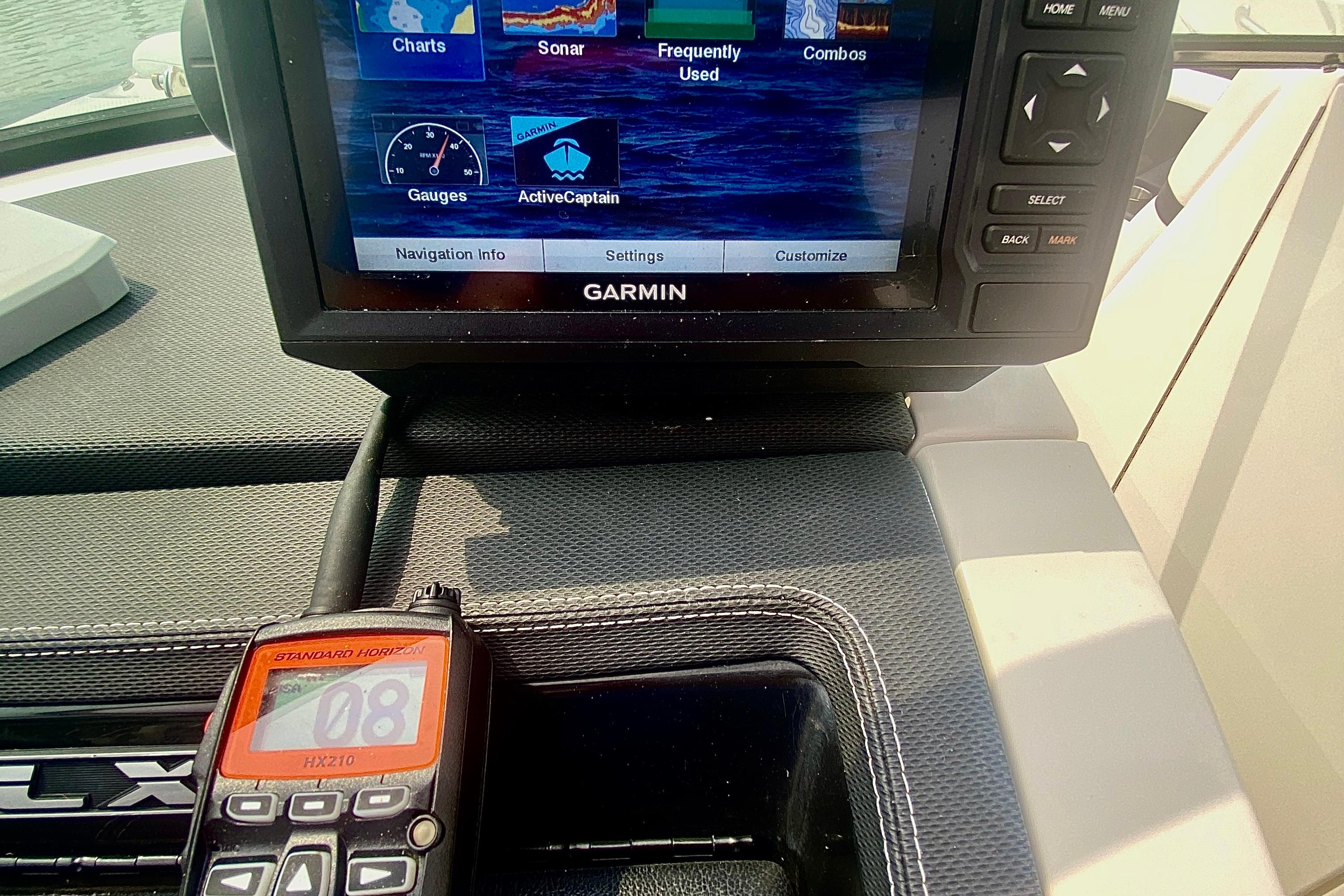 Garmin navigation system and radio on 2015 Sea Ray 250 SLX boat dashboard.