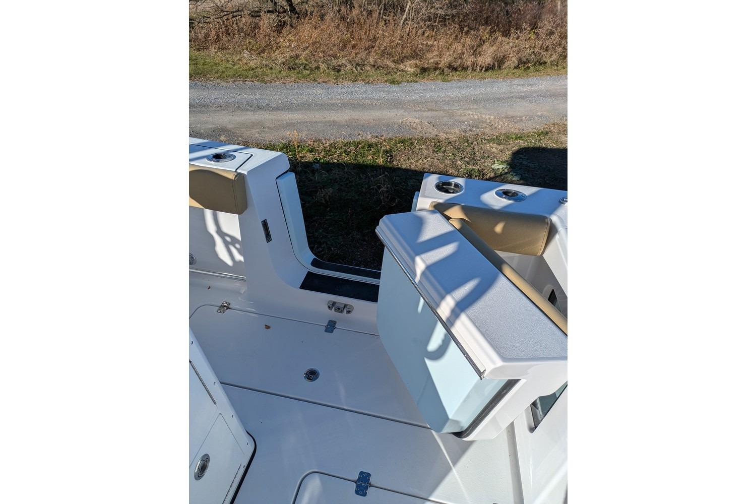 2025 Sportsman Open 282 Center Console boat interior with seating and cup holders.
