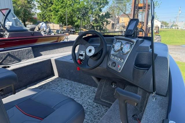 2026 Tracker Pro Guide V-16 SC boat interior with steering wheel and dashboard gauges.