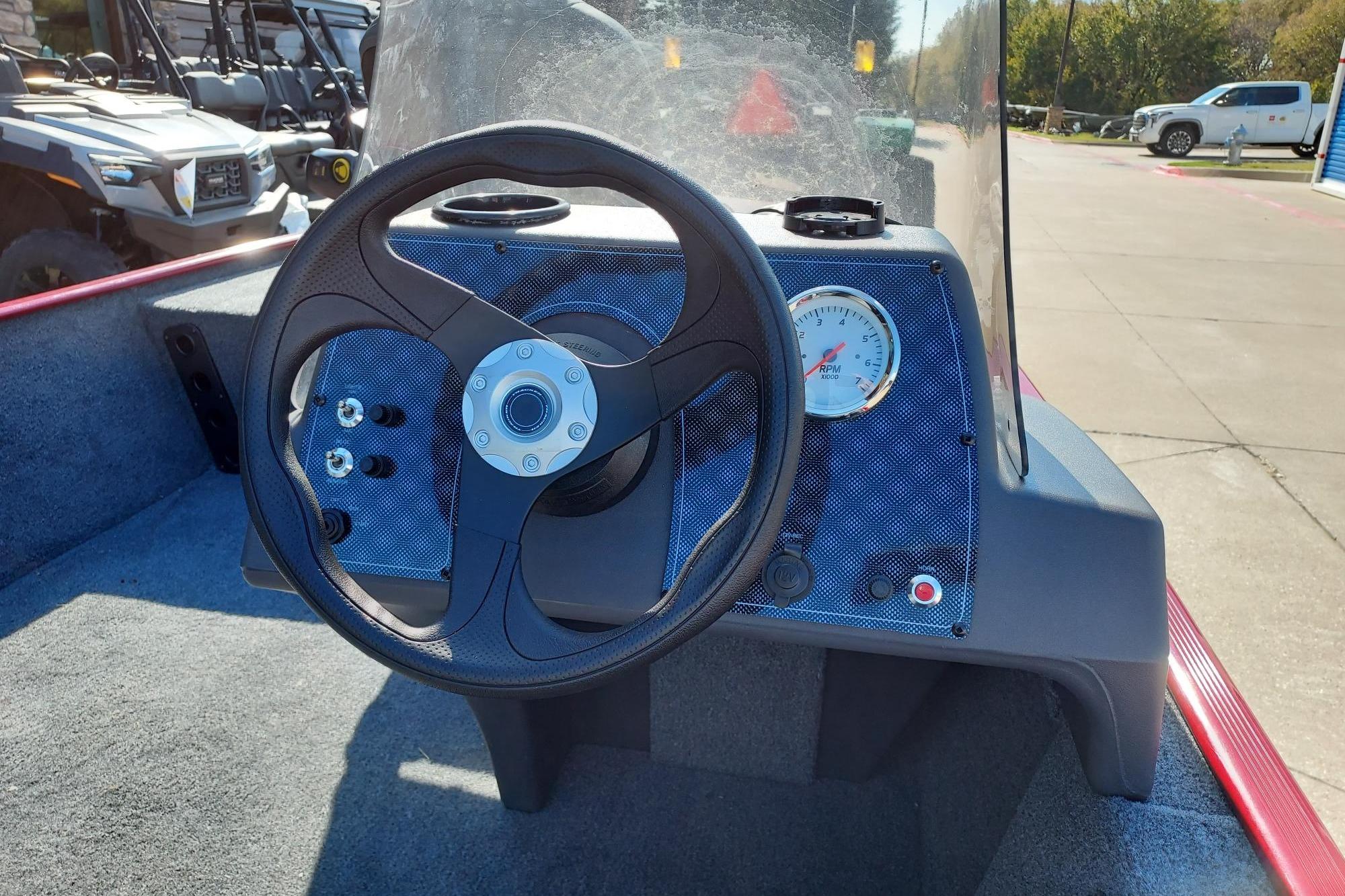 Steering console of 2026 Tracker Bass Tracker Classic XL boat with gauge and controls.