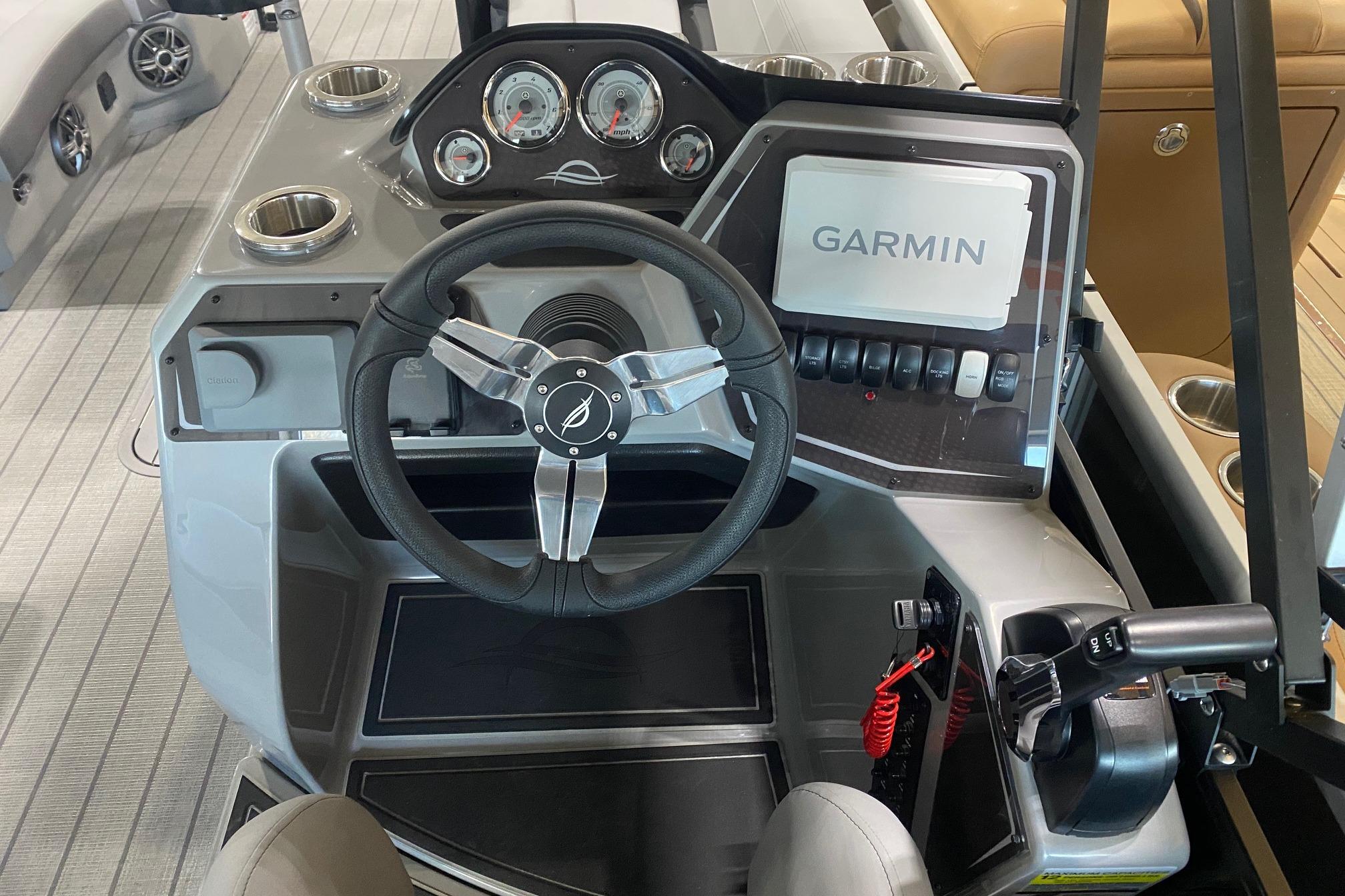 Steering console of 2026 SunCatcher Fusion 324SS with Garmin navigation system.