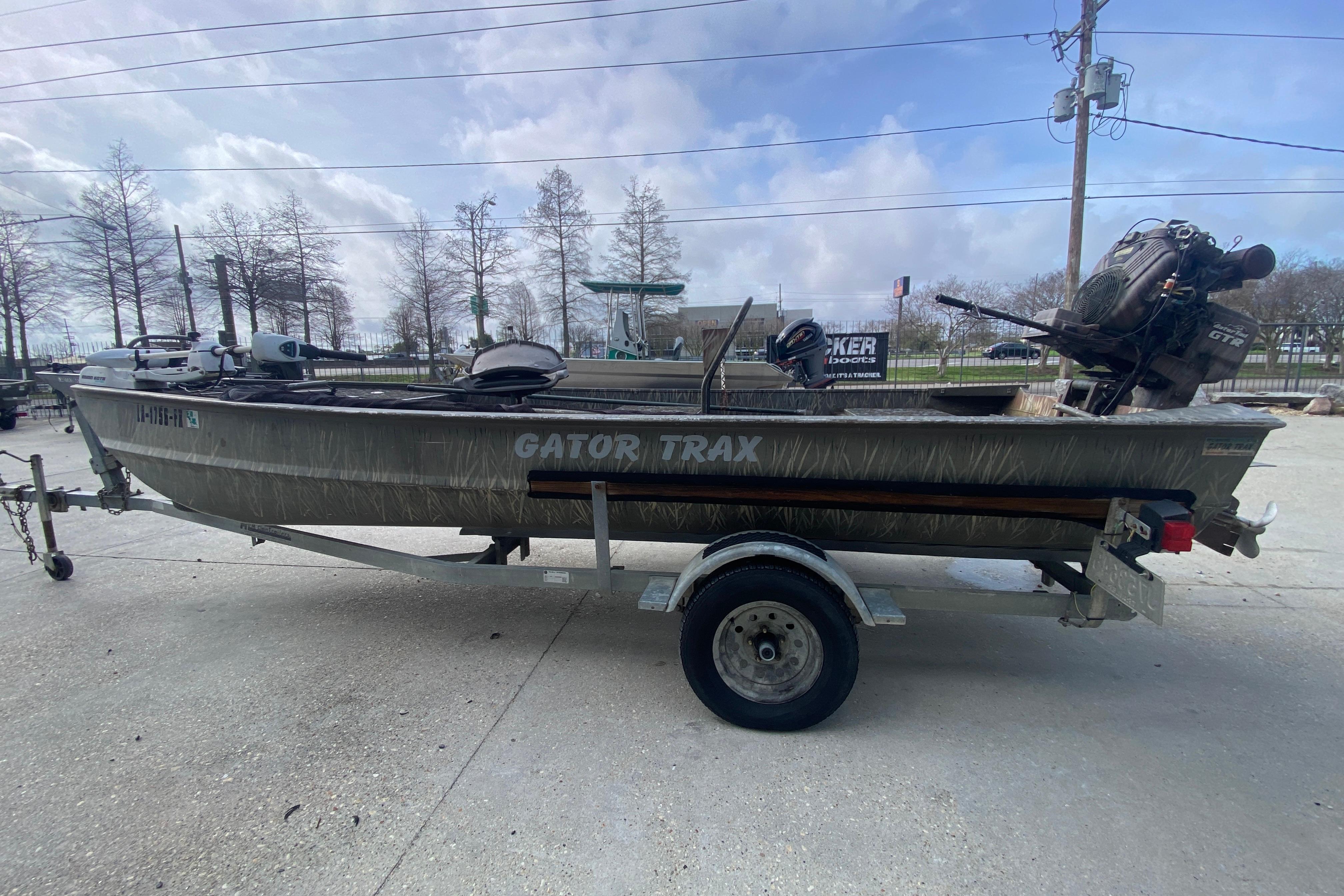2009 Gator Trax MUD BUDDY 17 X 50 boat on trailer, outdoor setting.