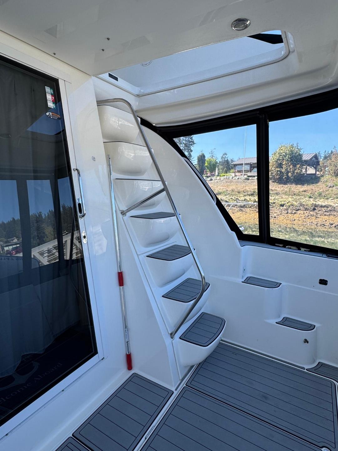 2003 Meridian 381 Sedan interior with sleek stairs and panoramic windows.