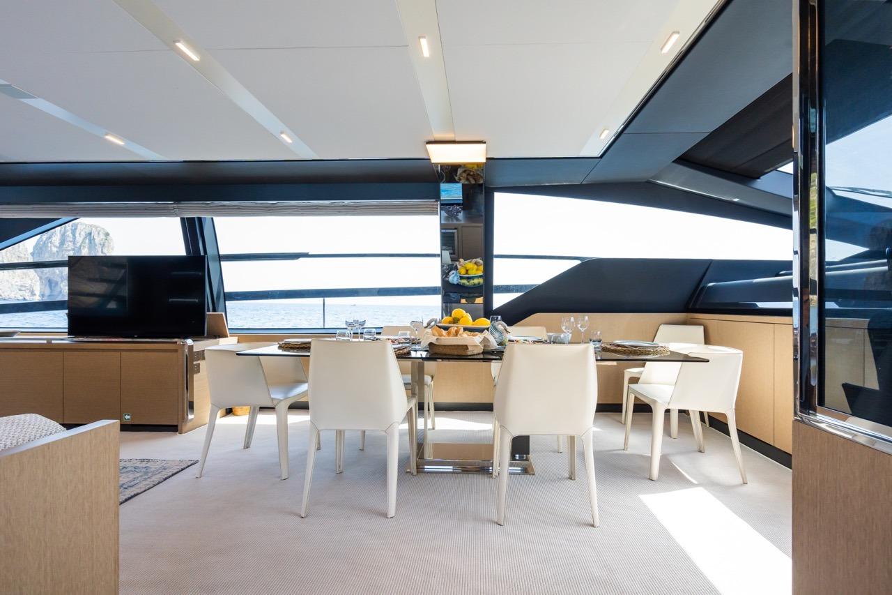 Luxurious interior of 2021 Riva 88 Folgore yacht with elegant dining area.