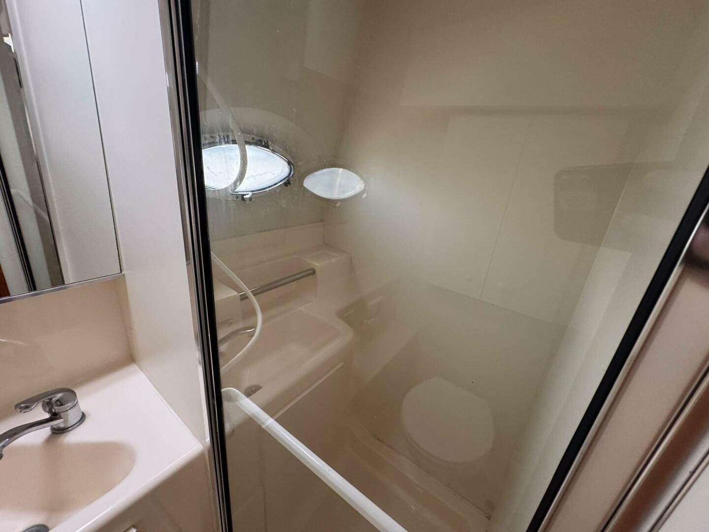 Bathroom interior of 2000 Silverton 322 Motor Yacht with shower and sink.