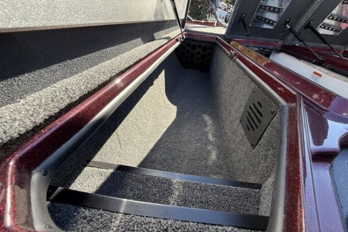 Interior storage compartment of 2026 Nitro Z21 XL Pro boat, featuring carpeted lining.