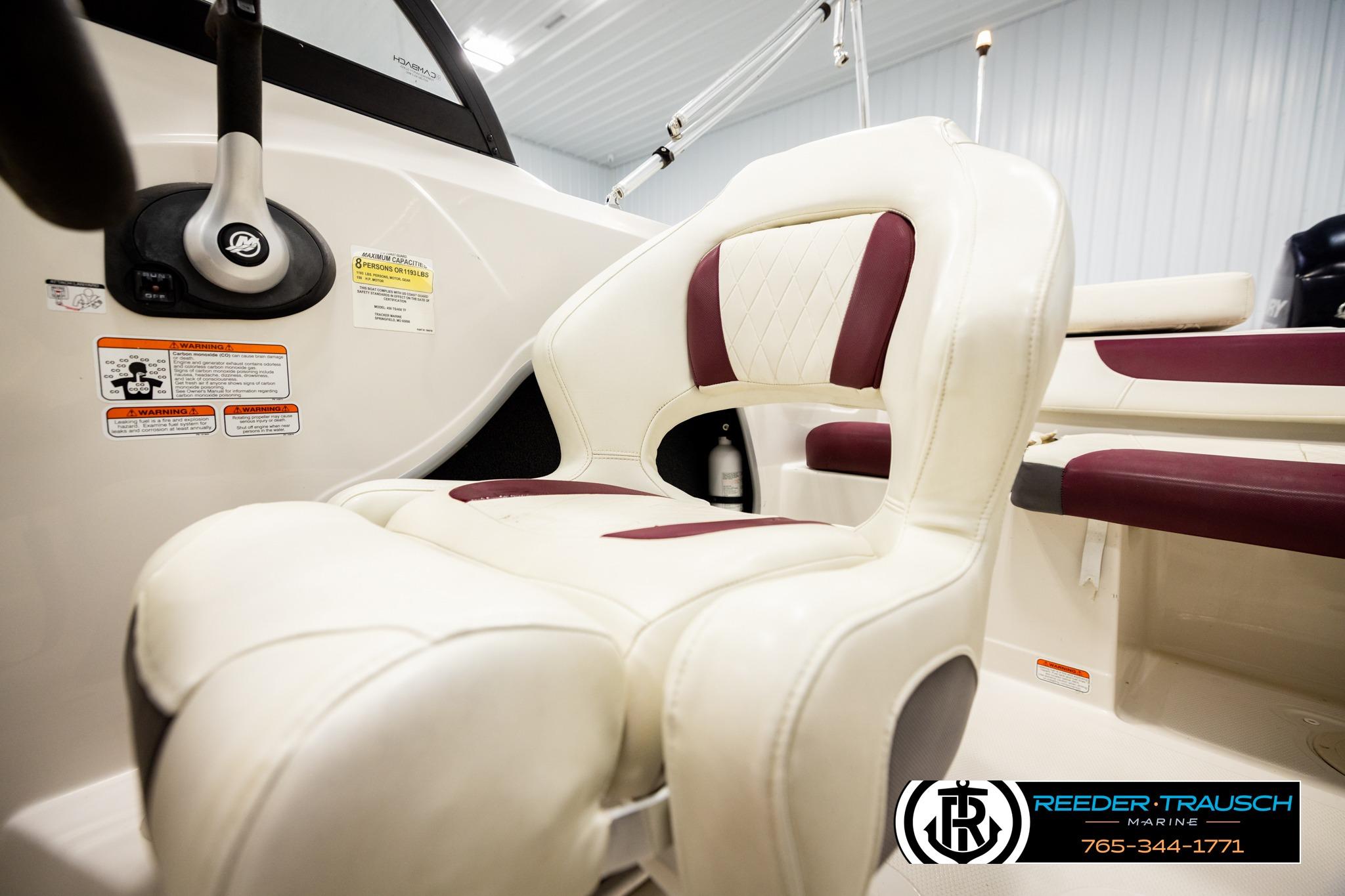 2016 Tahoe 450 TS boat interior with white and maroon seating, steering wheel visible.