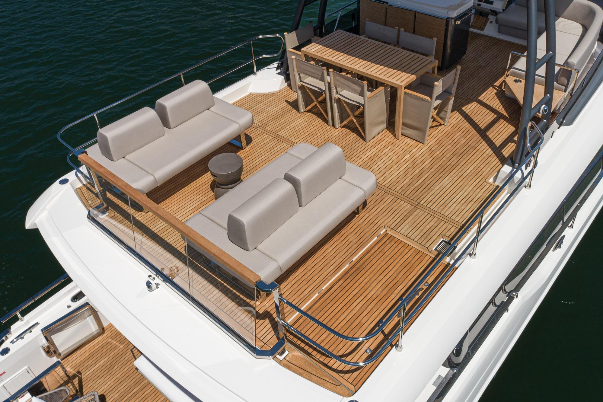 Luxurious 2024 Prestige X60 yacht deck with elegant seating and dining area.