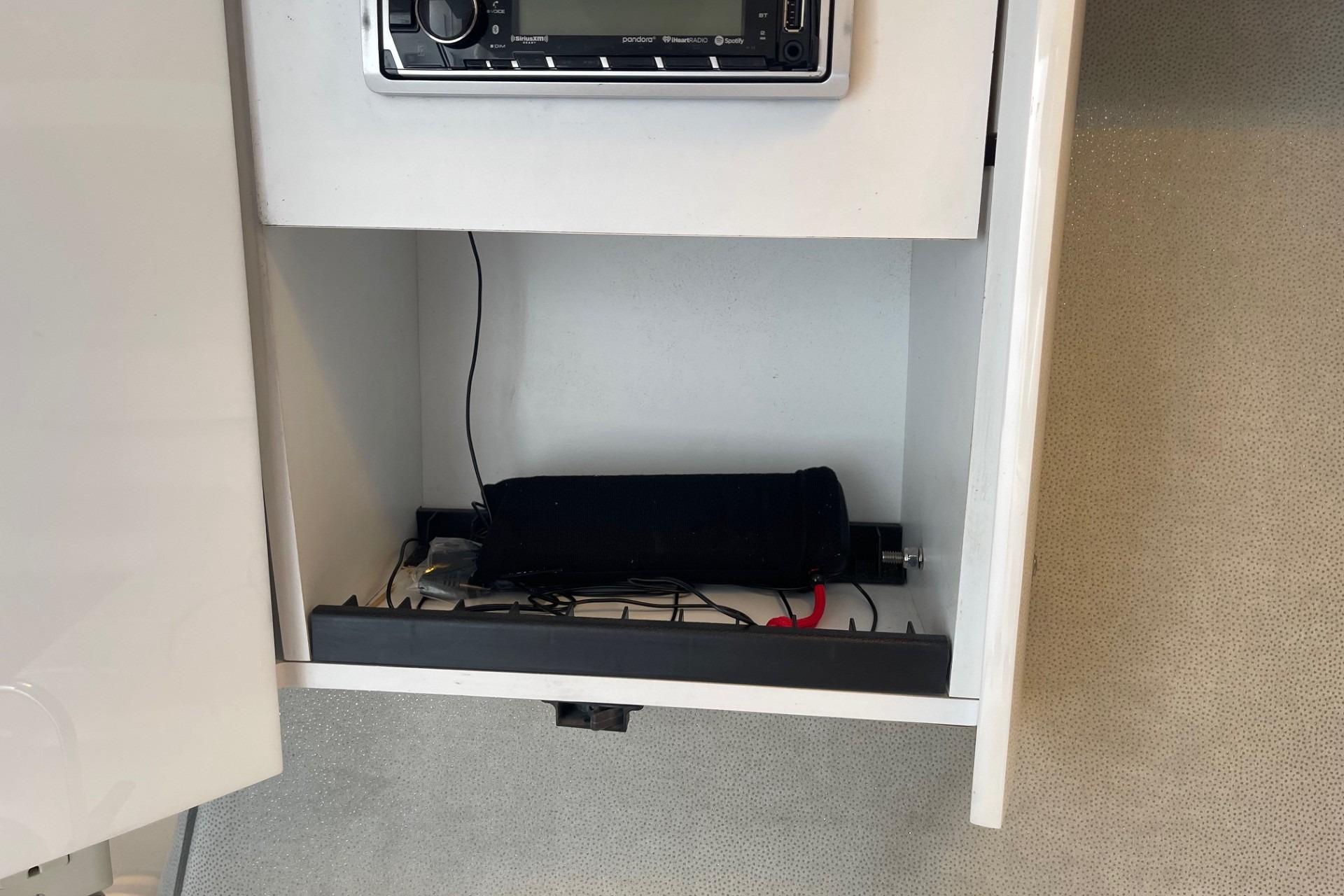 Open cabinet in 2004 Formula 382 FASTech boat with stereo system and wiring.