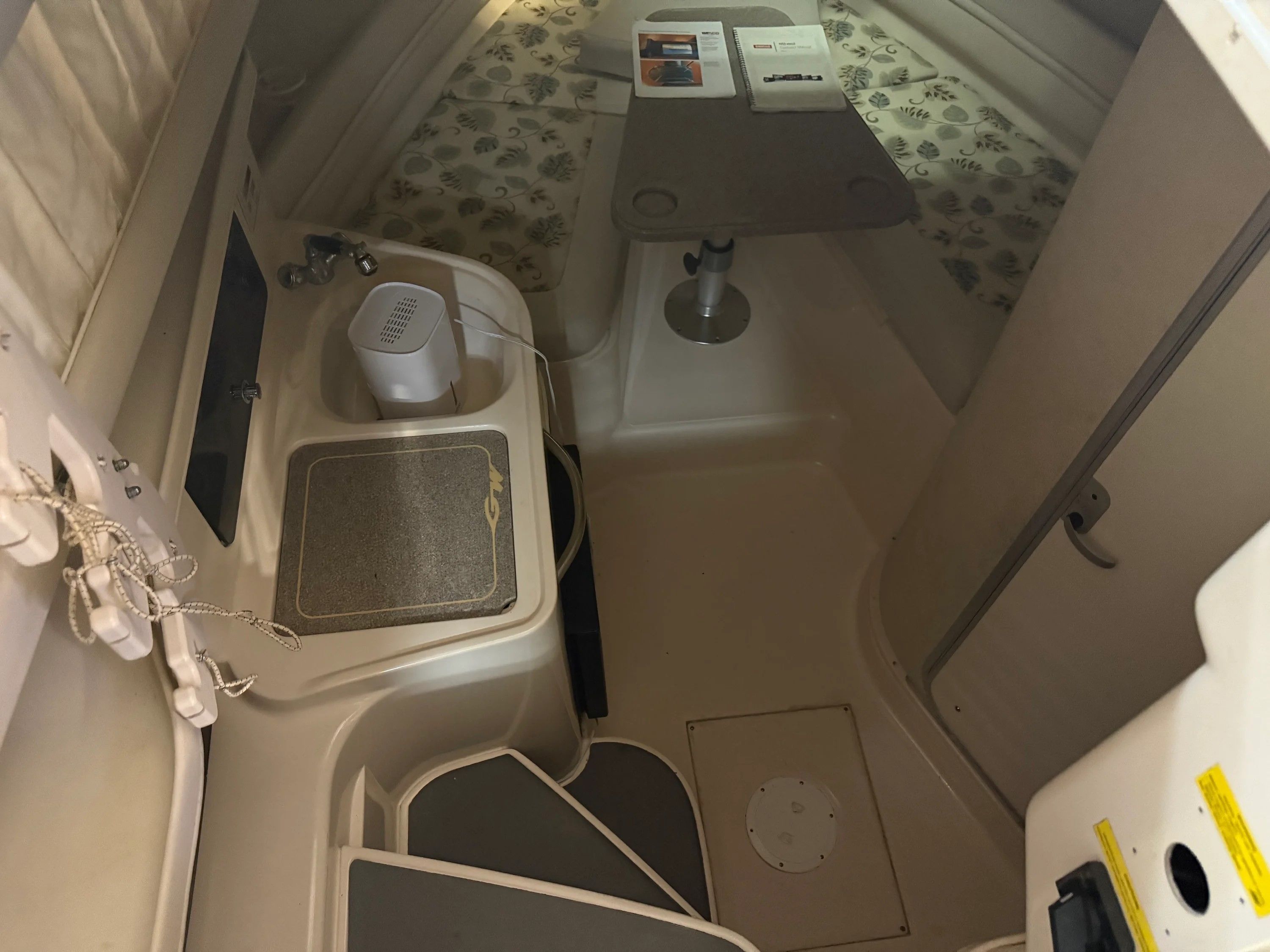 Interior of a 2002 Grady-White Marlin 300 with table and bed.