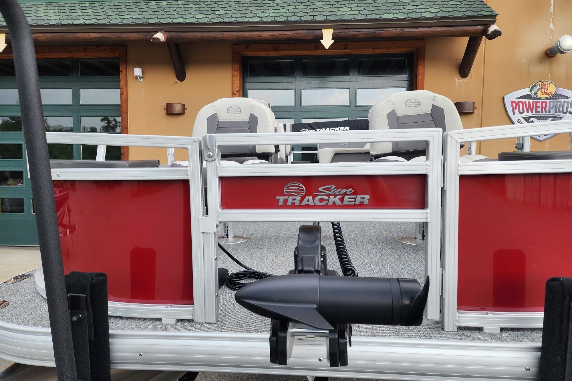 2026 Sun Tracker Bass Buggy 18 DLX pontoon boat with red exterior and seating.
