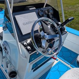 The image shows the helm of a ShearWater x22 boat with modern instruments.