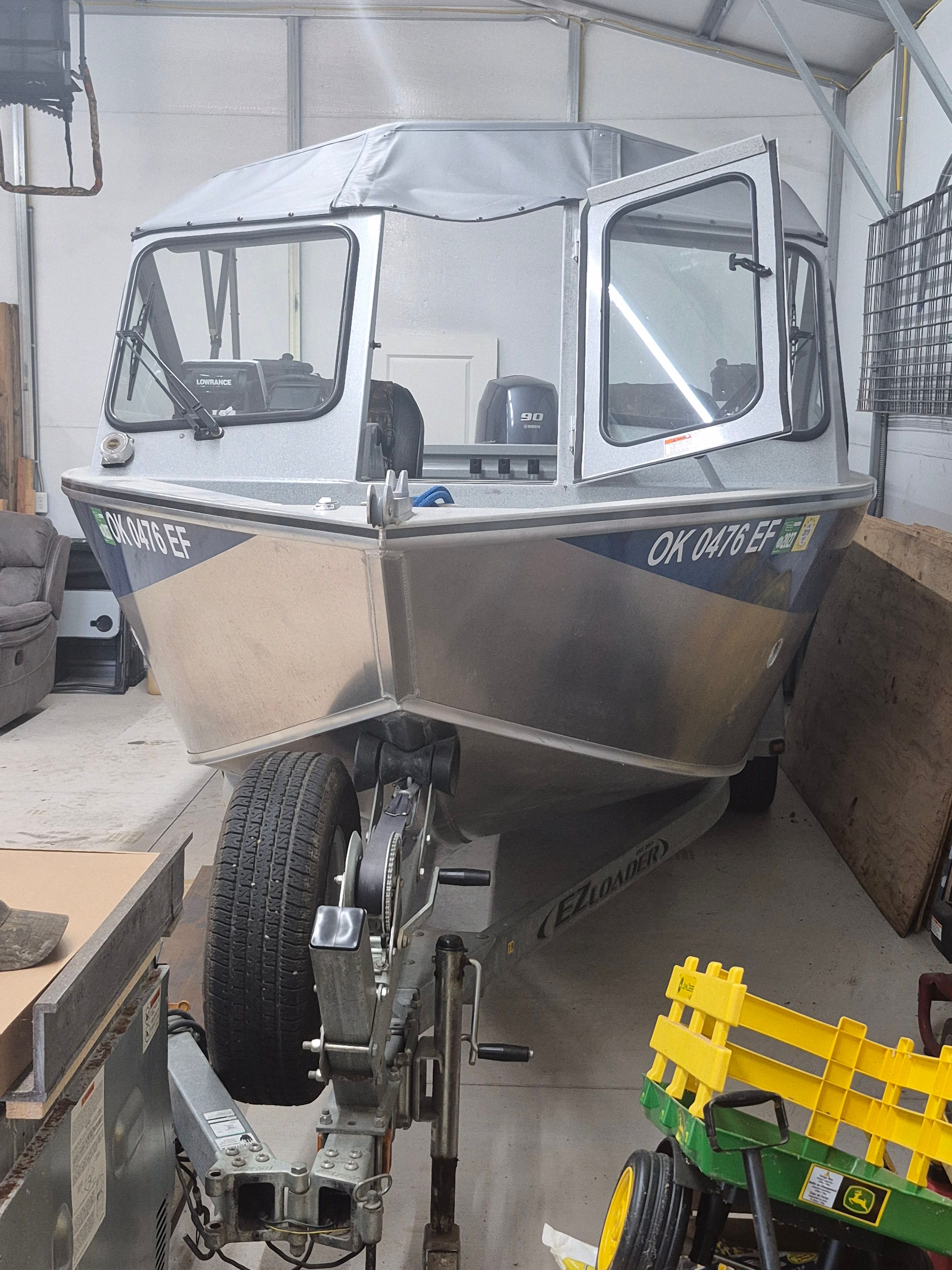 A 2016 Duckworth 18 Advantage boat on a trailer in a garage.