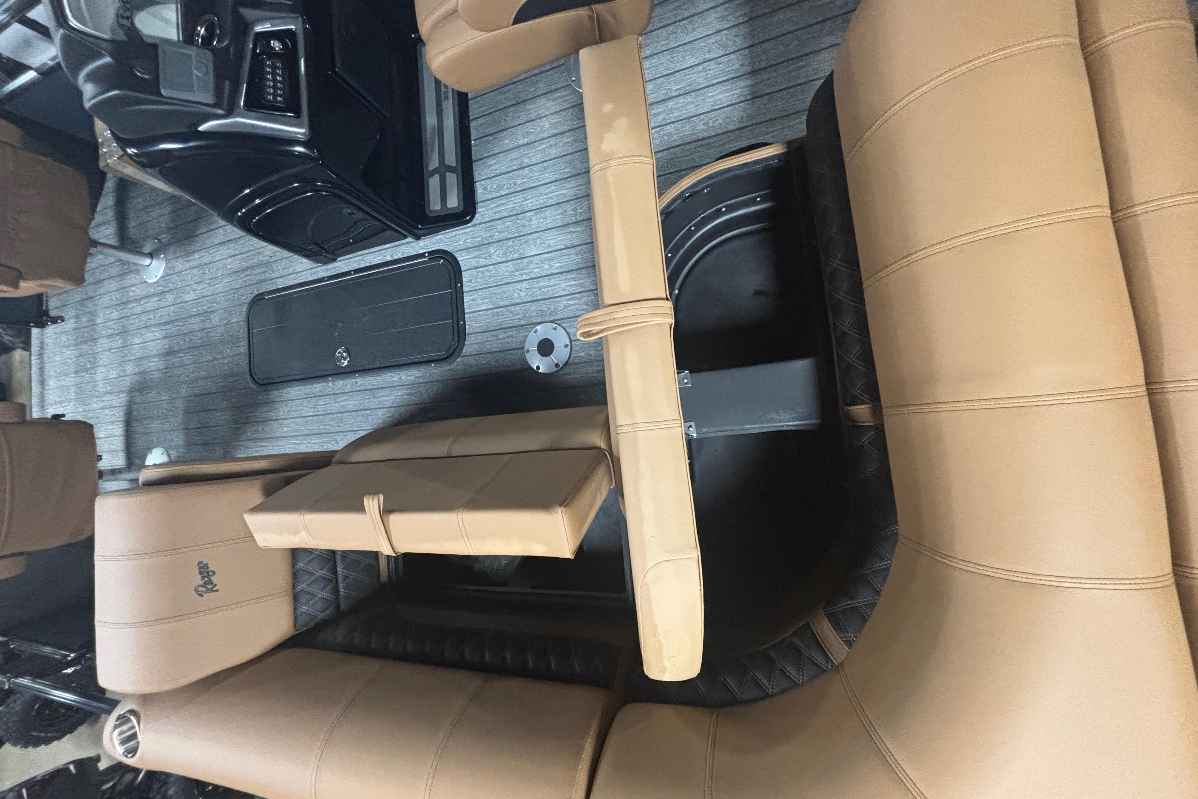 Interior of 2026 Ranger 223F boat with tan seating and black console.