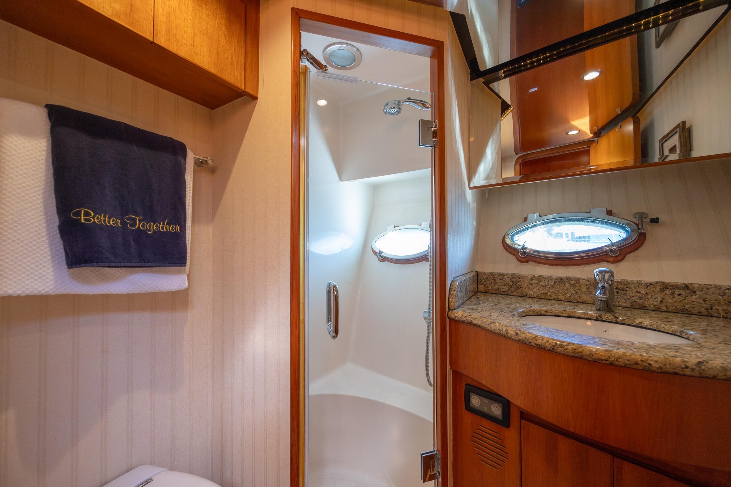 Luxurious bathroom in 2005 Ocean Alexander 52 Sedan yacht with granite countertop and shower.