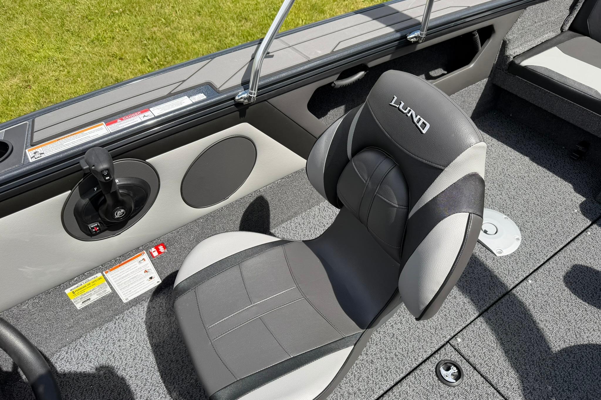 2027 Lund 1875 Crossover XS boat interior with gray seating and control panel.