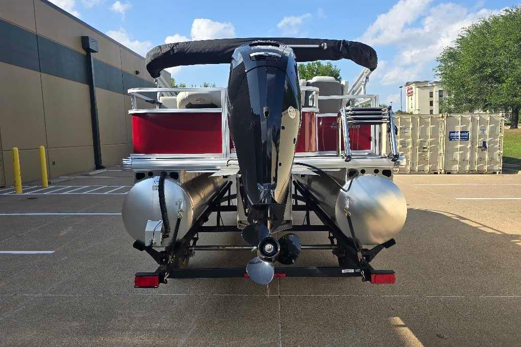 2026 Sun Tracker Bass Buggy 18 DLX pontoon boat, rear view, parked outdoors.