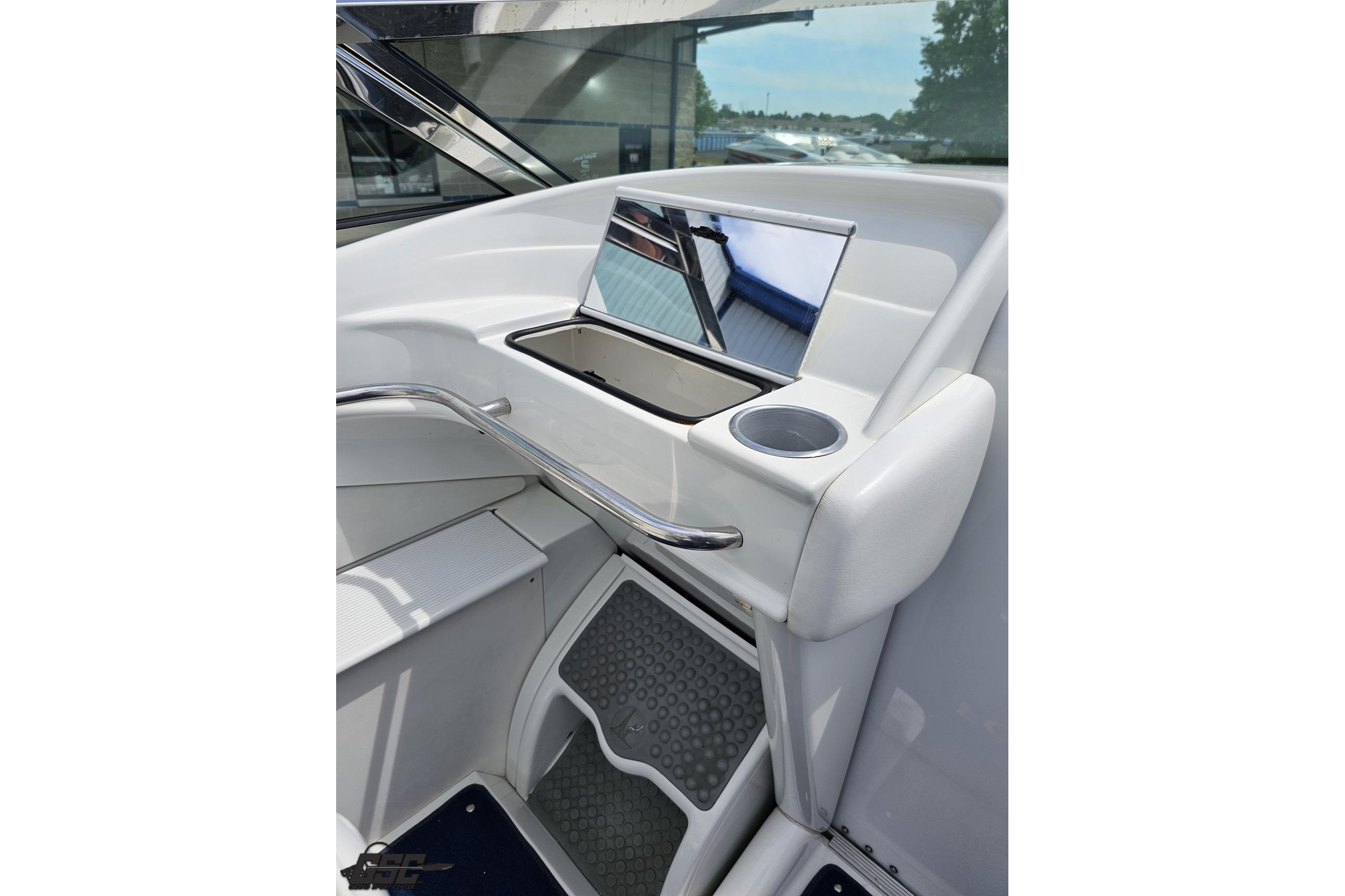 Interior view of a 2002 Formula 382 FASTech boat, featuring sleek white design and cup holder.