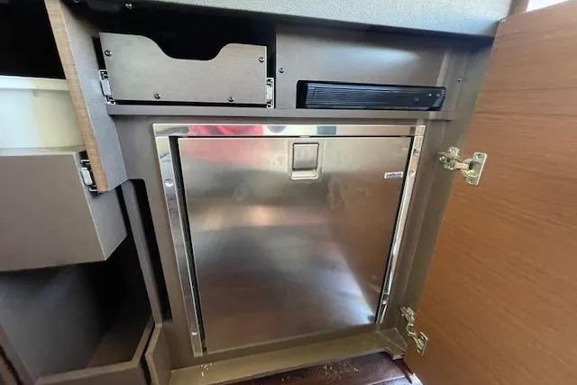 Stainless steel refrigerator inside 2016 Sea Ray Sundancer 510 yacht kitchen area.