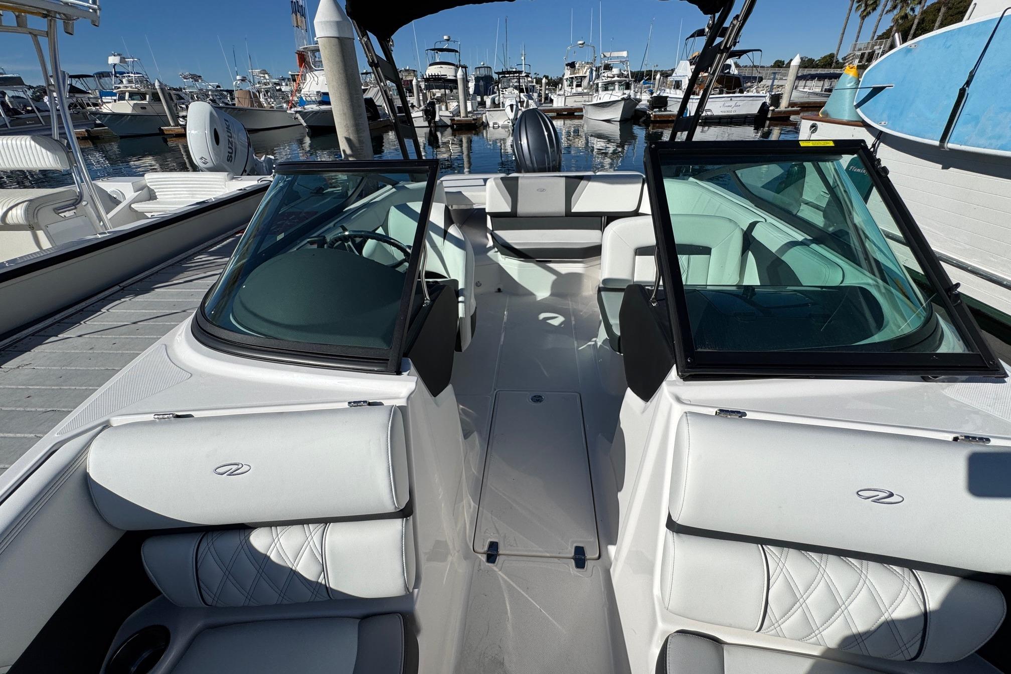 2026 Regal 21 OBX boat interior at marina, featuring sleek design and comfortable seating.