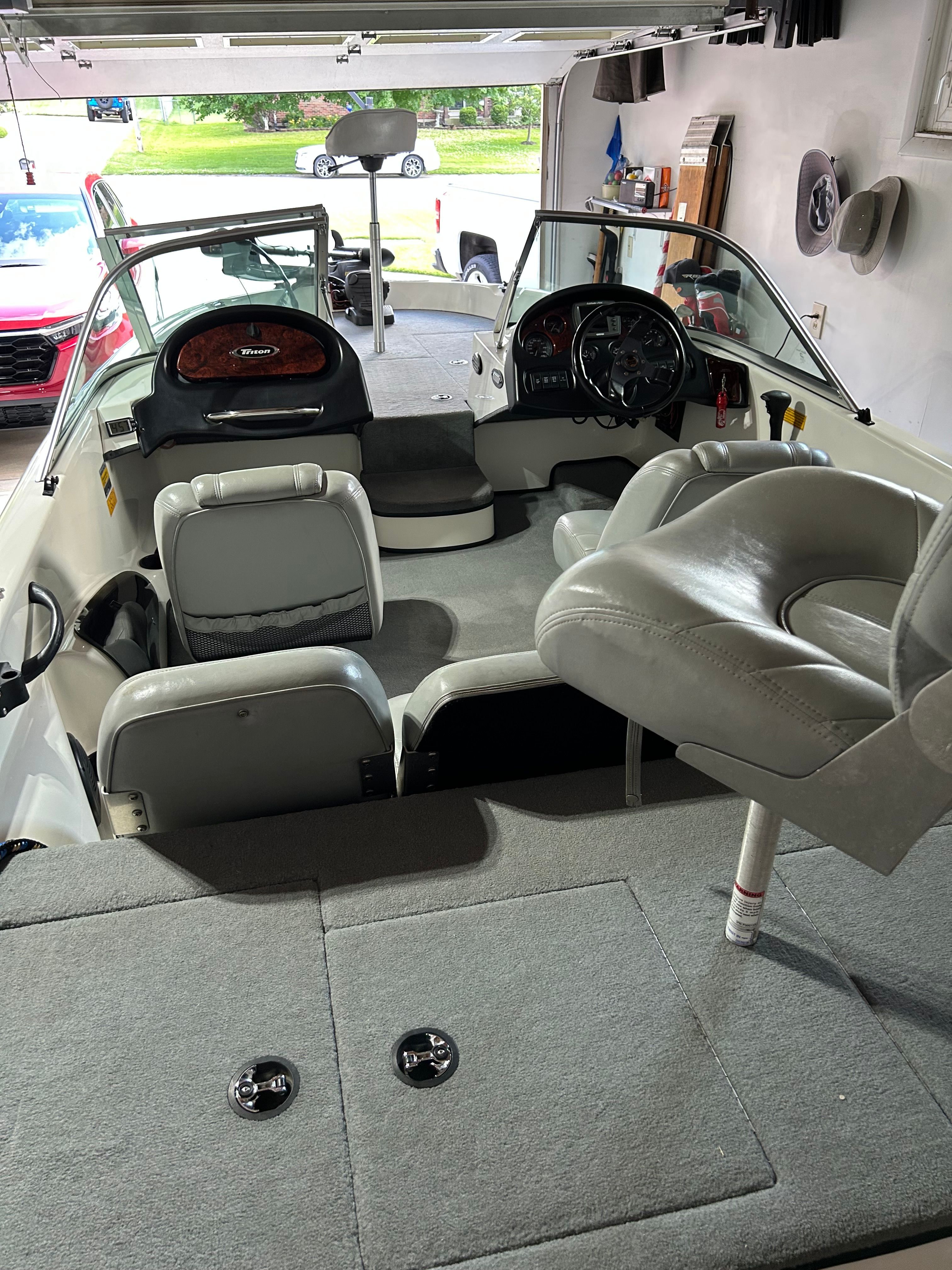 Interior view of a 2003 Triton 190FS boat in a garage.