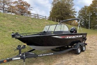 2026 Tracker Pro Guide V-175 WT boat on trailer, parked on grassy area.