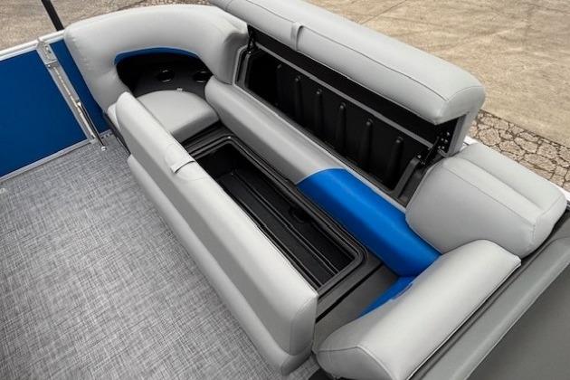 2026 Sun Tracker Party Barge 20 DLX interior seating with storage compartment.