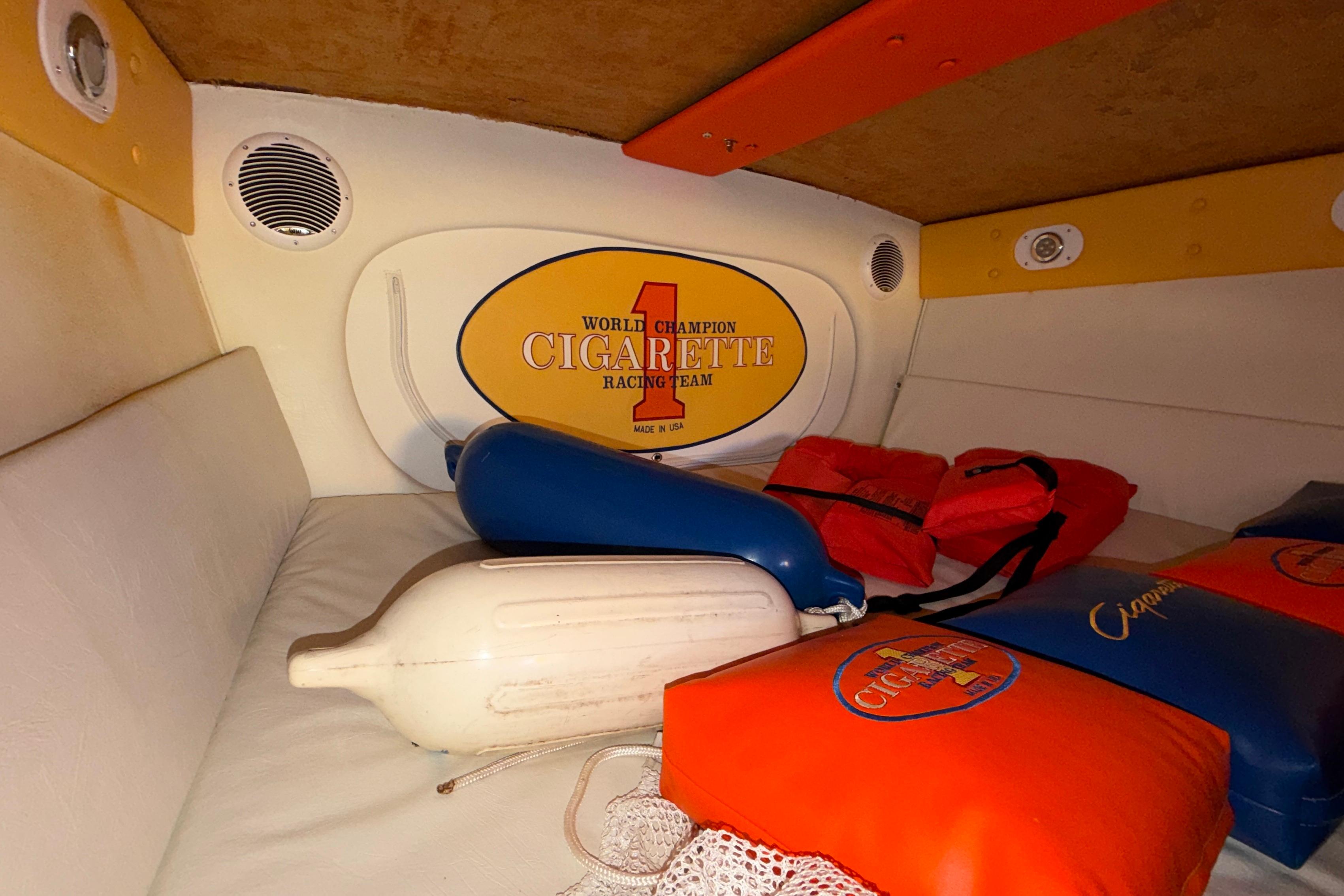 Interior of a 2002 Cigarette 35' Cafe Racer with branded cushions and life vests.