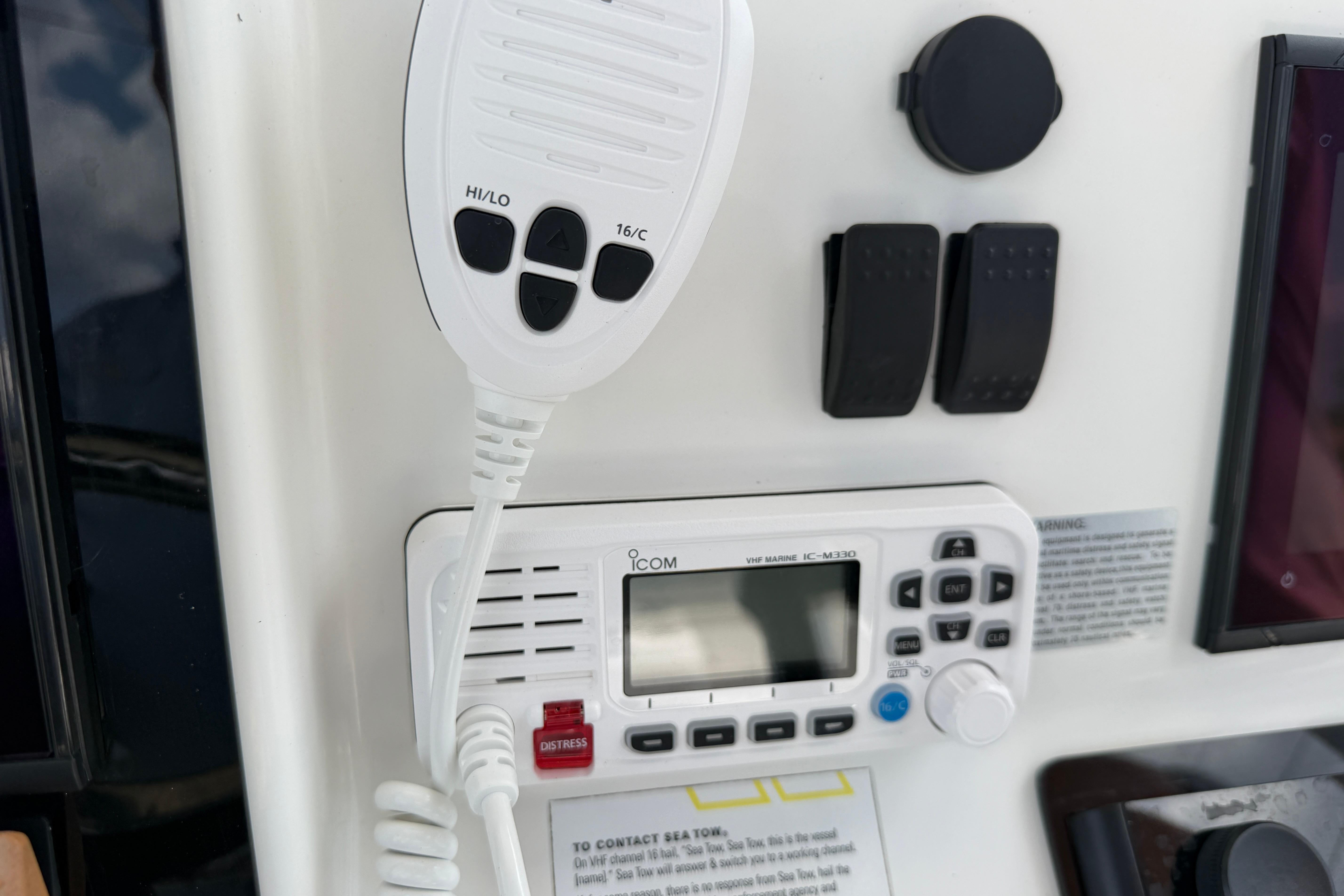Control panel of a 2015 Sea Hunt Triton 225 boat with VHF marine radio.