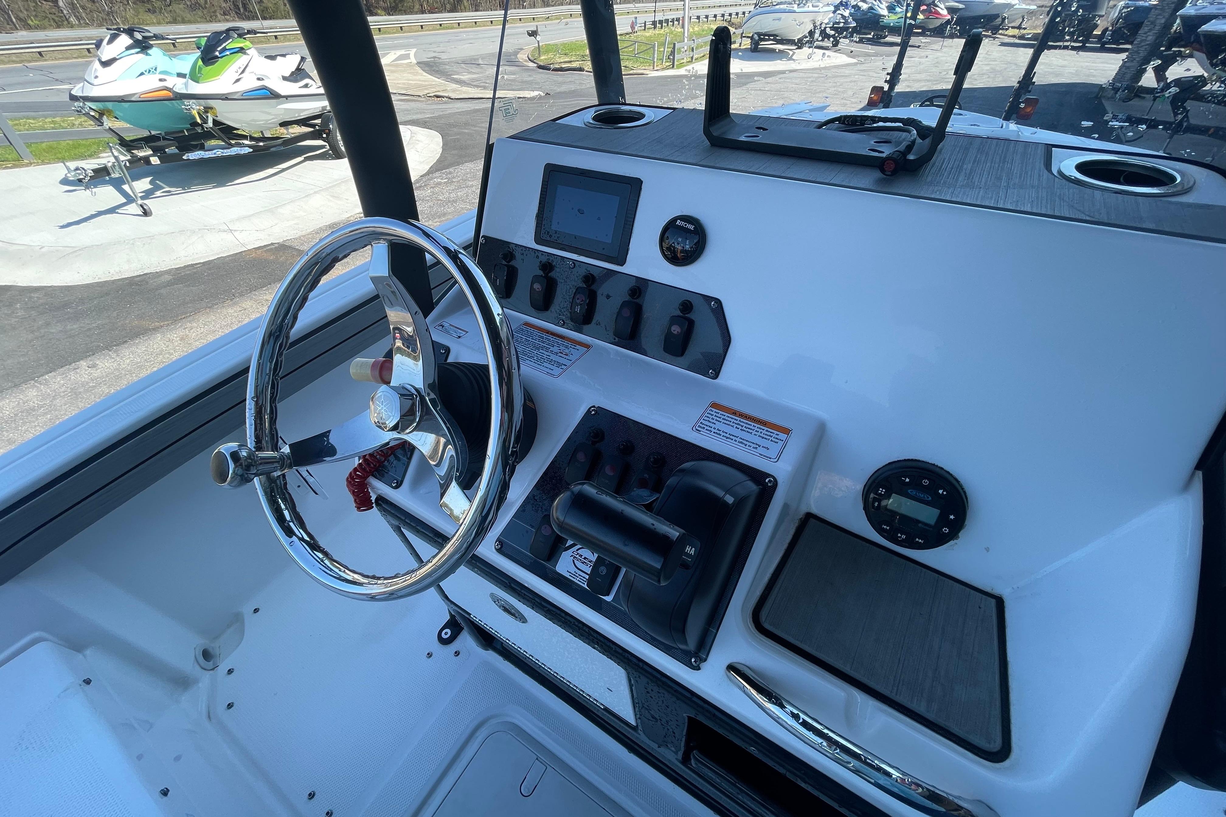 2021 Yamaha Boats 195 FSH Sport dashboard with steering wheel and controls.