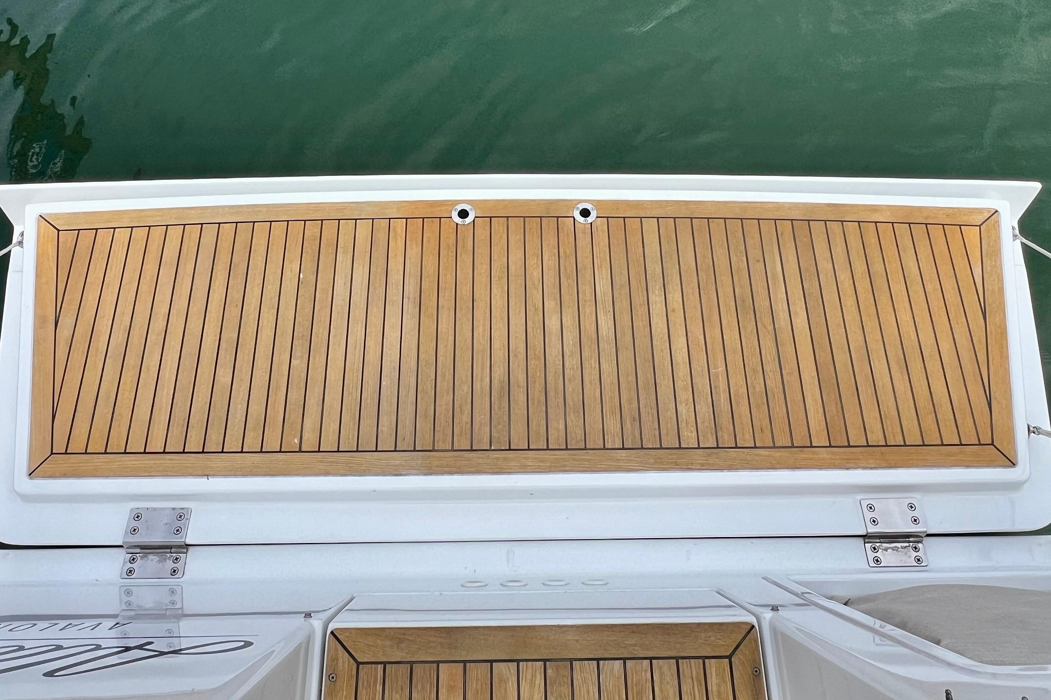 Teak deck of 2016 Hanse 455 yacht, featuring sleek wood paneling and stainless steel fittings.