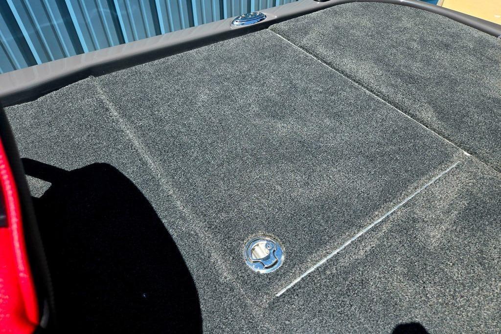 Carpeted deck of 2026 Skeeter ZXE20 boat with storage hatch.