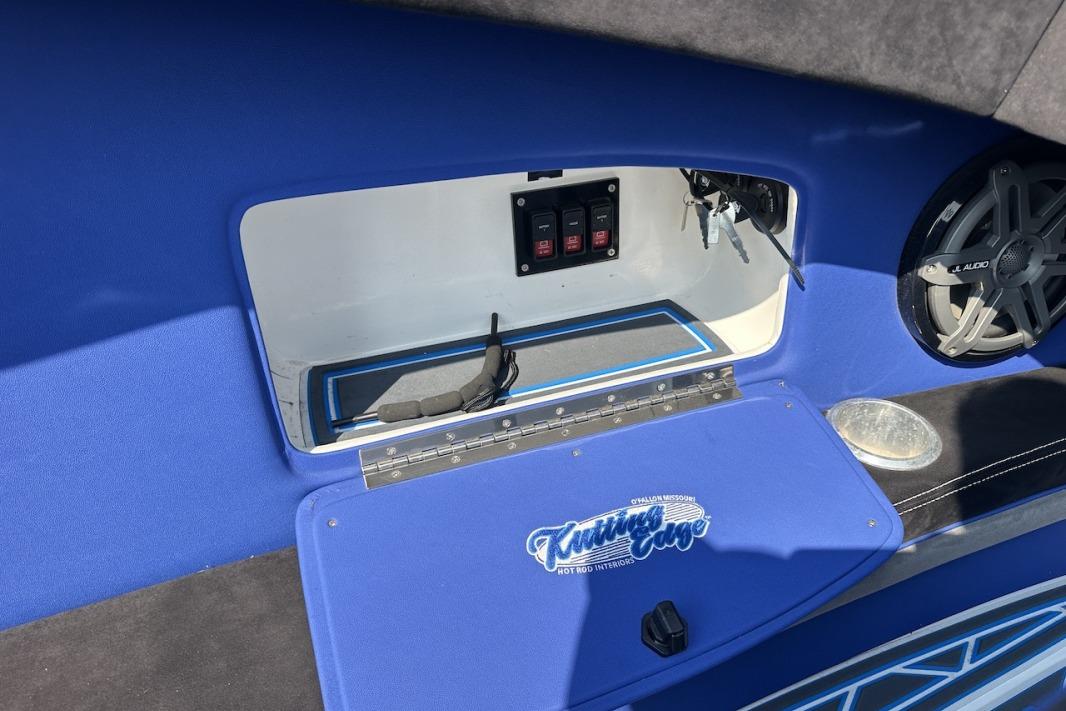 Interior of a 2018 Wright Performance 420 boat with blue accents and audio system.