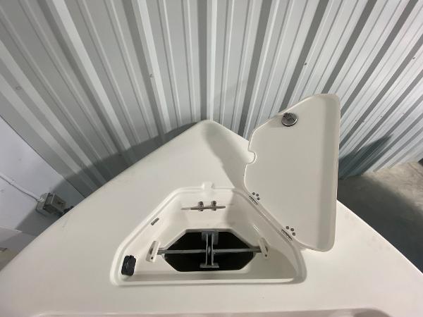 2024 Key West 203 FS boat anchor storage compartment with open hatch.