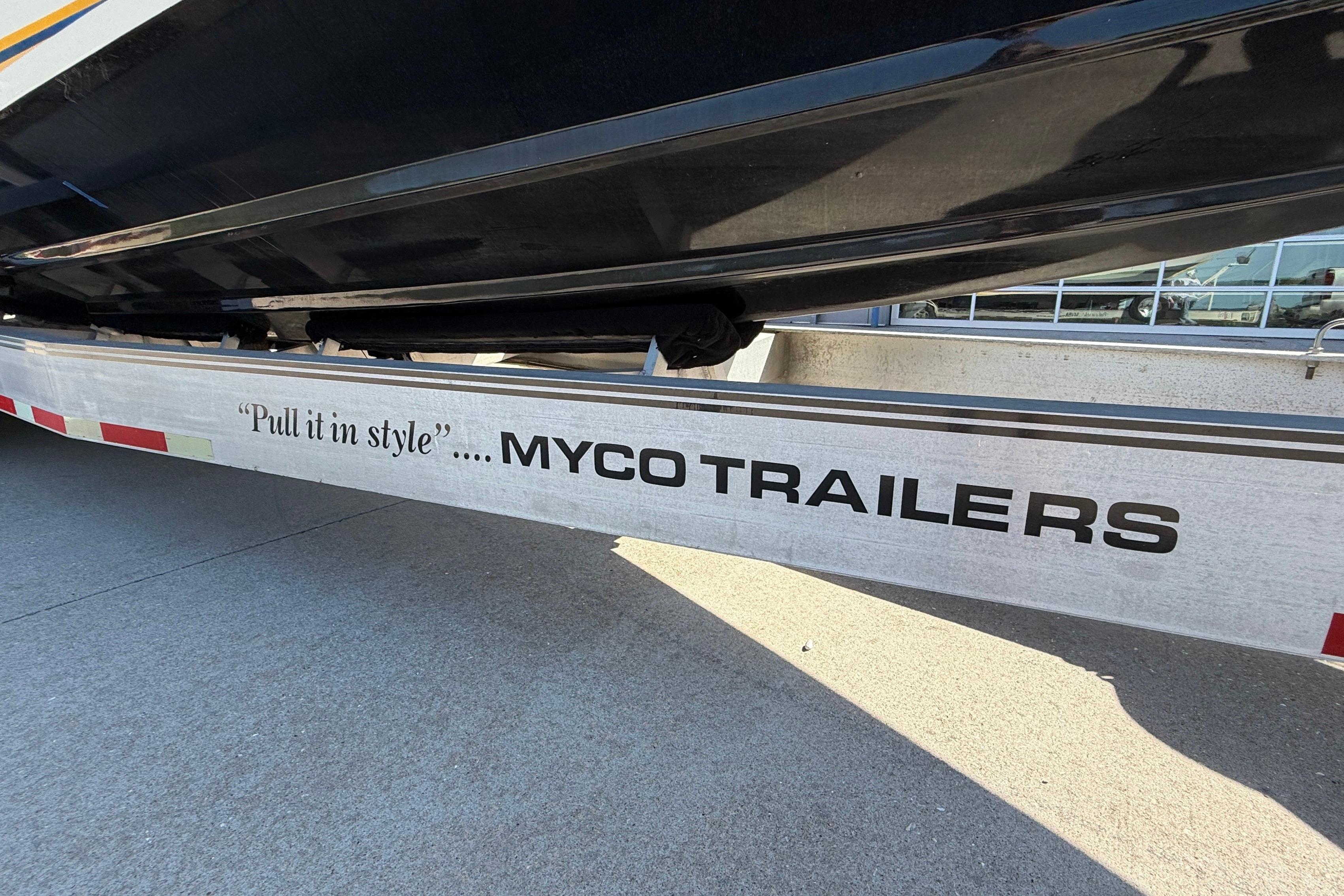 Trailer with "Pull it in style" slogan, supporting a 2002 Cigarette 35' Cafe Racer boat.