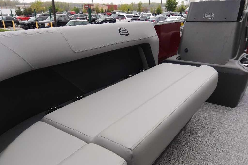 2026 Sun Tracker Party Barge 16 DLX interior with gray seating and console.