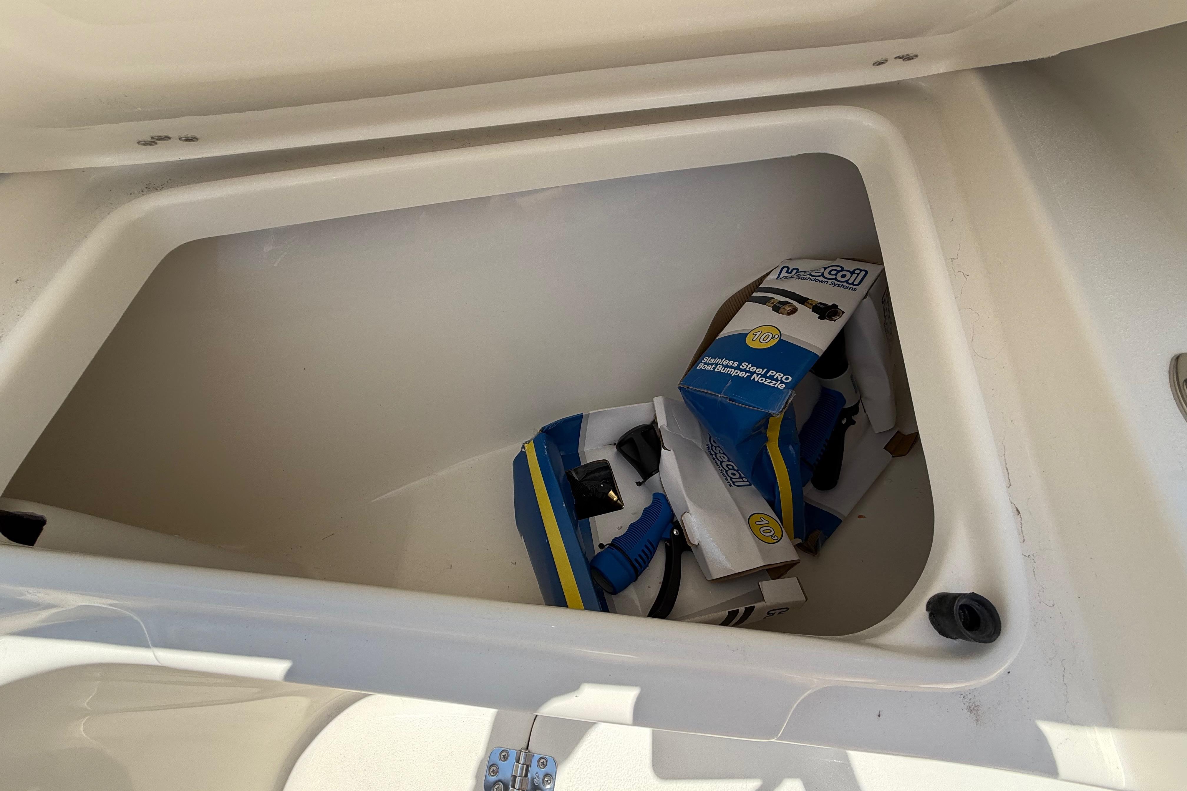 Storage compartment of 2027 Key West 249 FS boat with accessories inside.