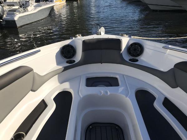 2020 Rinker 29QX BR boat interior, bow seating area with speakers.
