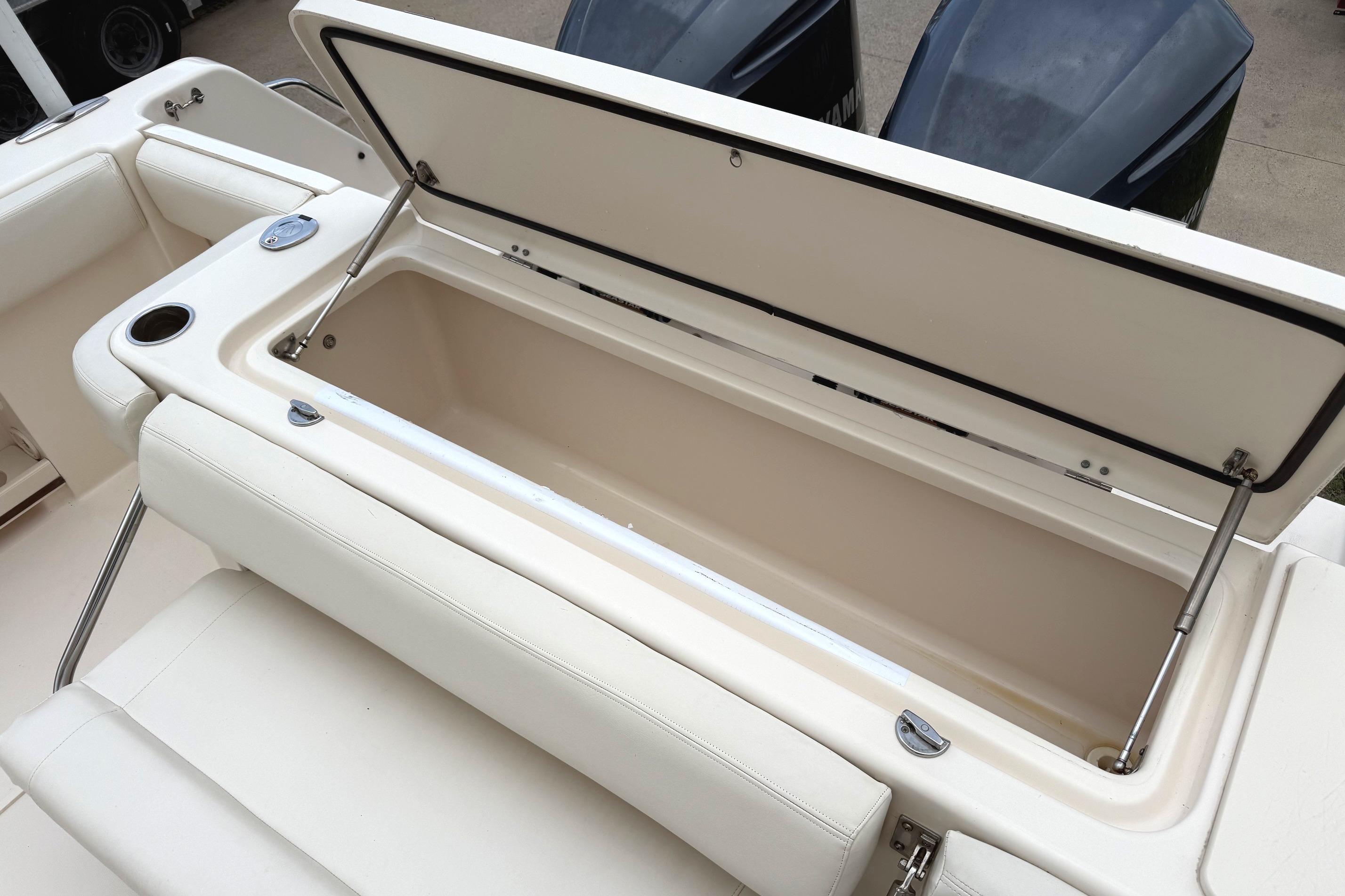 Open storage compartment on 2018 Grady-White Canyon 306 boat, showcasing spacious interior.