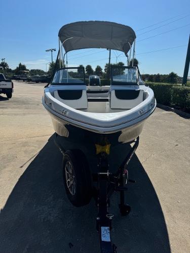 2025 Tahoe 200 S boat with canopy on trailer in sunny outdoor setting.